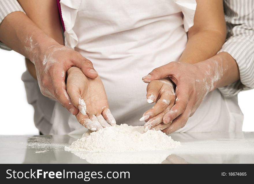 Young loving couple playing with dough. Over white background