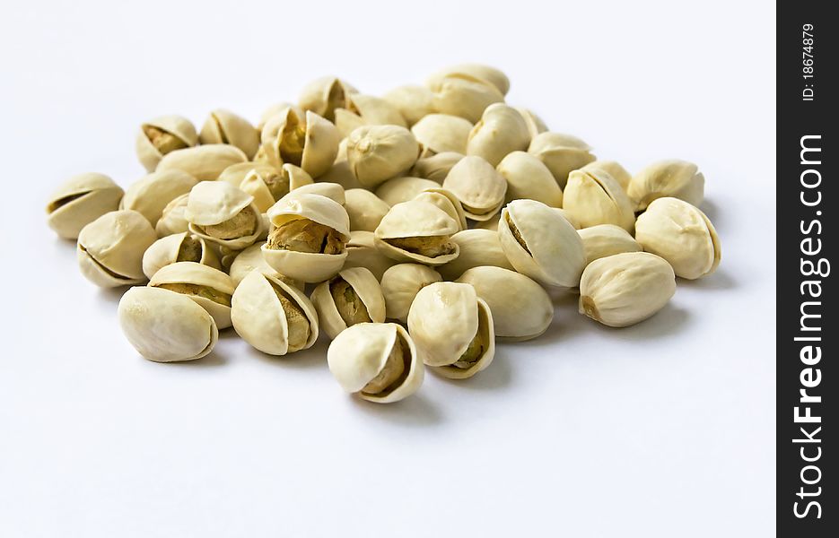 Pistachio nuts with shell in shallow depth of field on seamless background. Pistachio nuts with shell in shallow depth of field on seamless background.