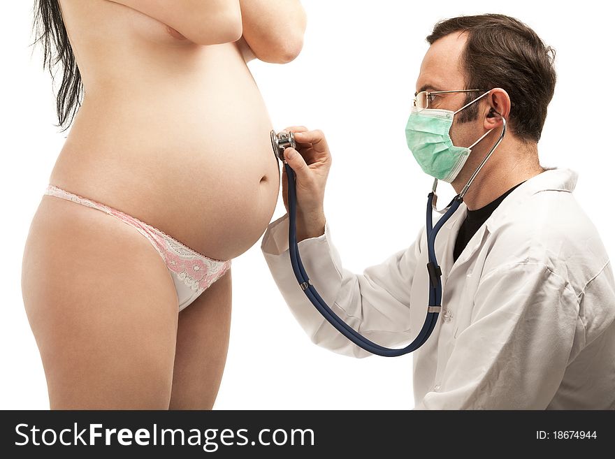 Pregnant woman being examined by a male doctor holding a stethoscope on the stomach, isolated on white background. Pregnant woman being examined by a male doctor holding a stethoscope on the stomach, isolated on white background