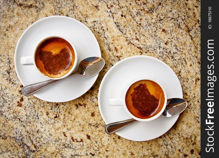 Two cups of coffee on a granit table. Two cups of coffee on a granit table.