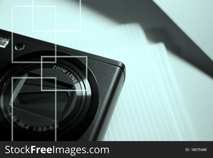 Image of a compact camera and blurred background. Image of a compact camera and blurred background.