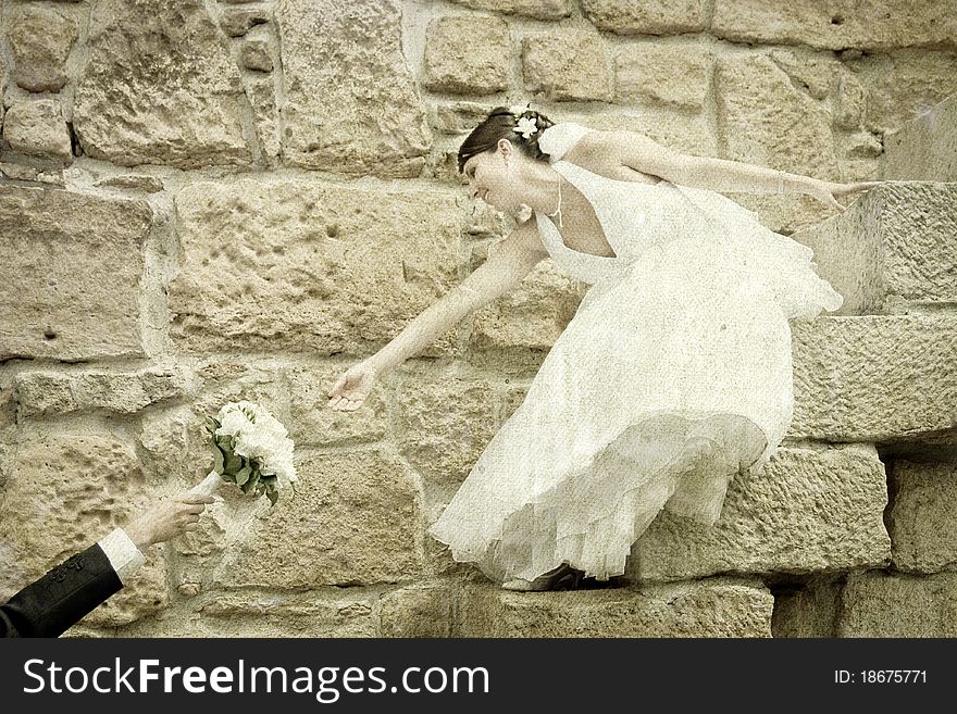 Vintage photo of bride reaching for her bouquet