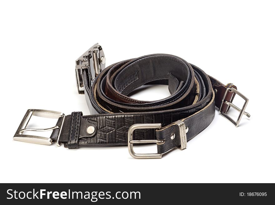 Old leather belts are isolated on a white background
