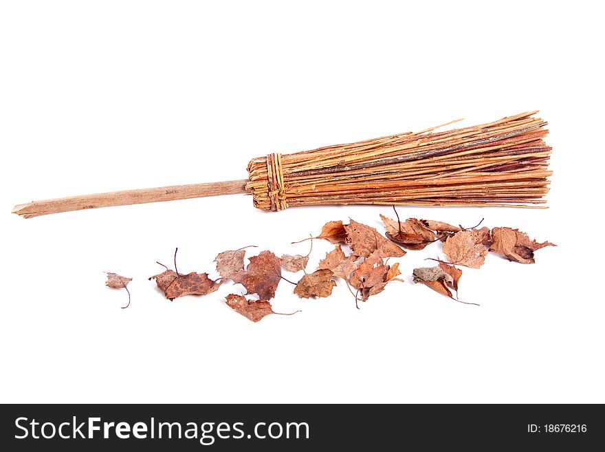 Gardening with wooden broom with dried brown leaves isolated over a white background. Gardening with wooden broom with dried brown leaves isolated over a white background