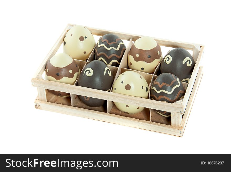 Eight painted easter eggs in a wooden tray isolated over white background