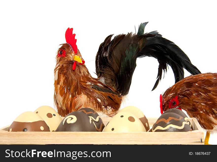 Two chickens near a box of easter eggs isolated on white. Two chickens near a box of easter eggs isolated on white