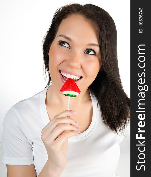 Pretty girl with candy on a white background