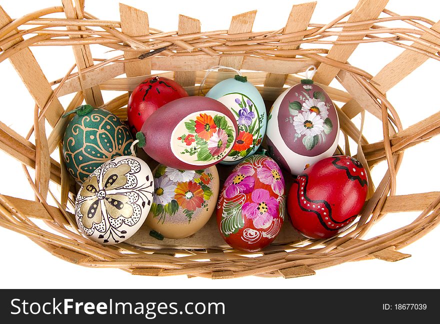 Painted easter eggs in basket with white background