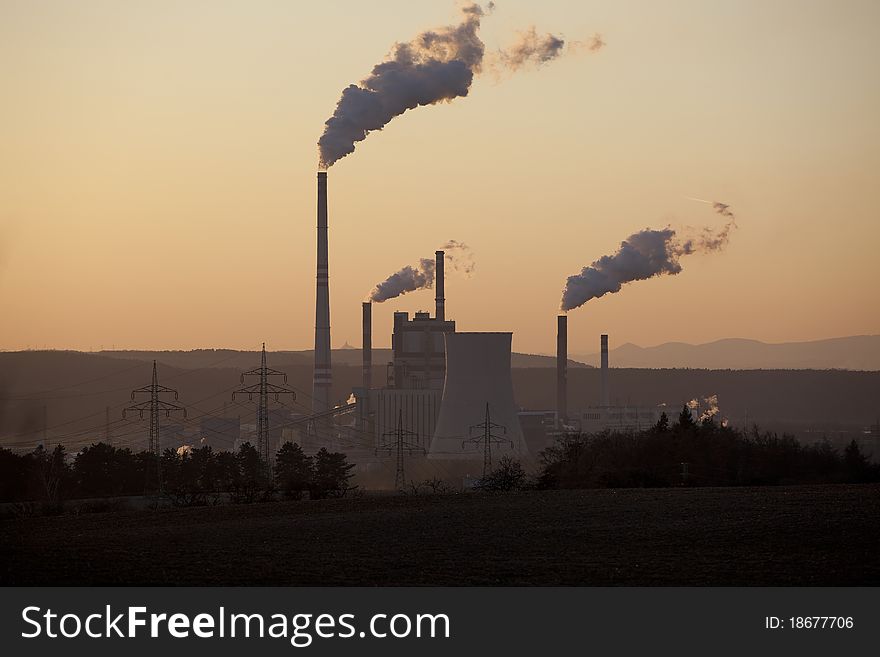Power plant in sunset, smoking, ecology