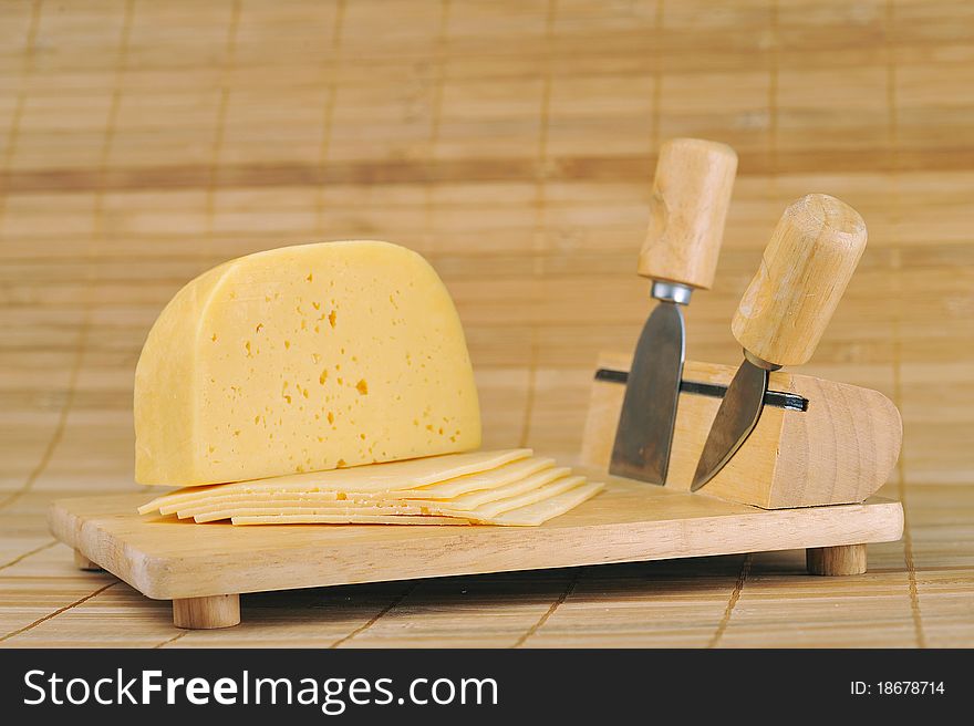 Wooden plate and knives for cutting cheese. kitchenware