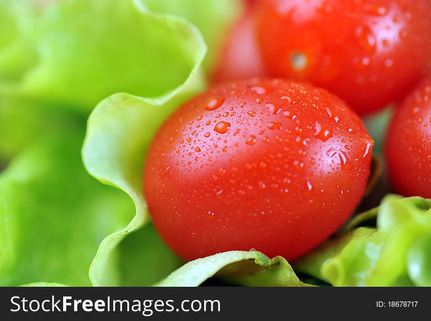 Ripe and juicy cherry tomatoes and lettuce  on  bamboo napkin