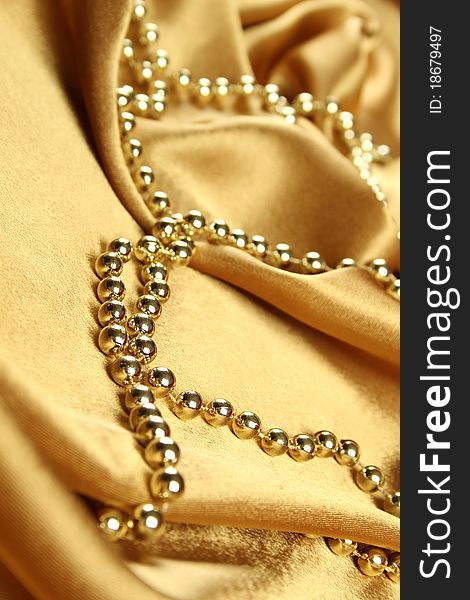 Background of gold cloth on which lay the golden beads. Background of gold cloth on which lay the golden beads