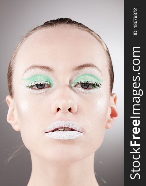 Confident beautiful woman portrait with unusual green-white make-up. Confident beautiful woman portrait with unusual green-white make-up