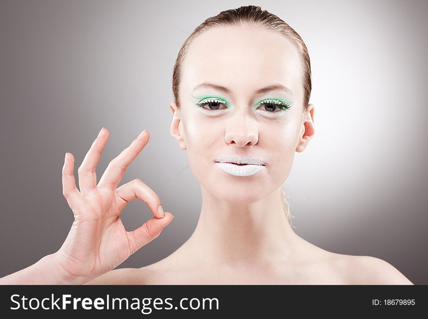 Beautiful young smiling happy woman make okay sign