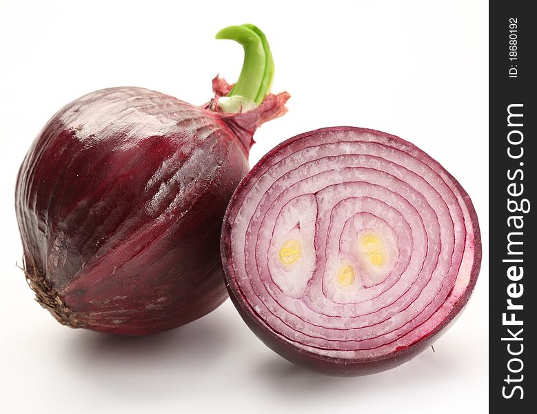 Bulbs of red onion with green leaves