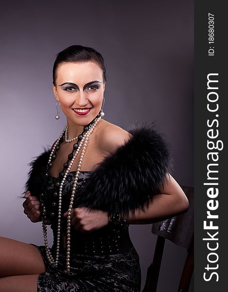 Proud woman smile in fur boa with pearl beads