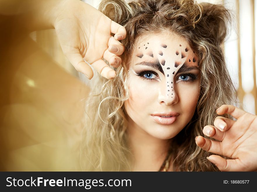 Girl with an unusual make-up as a leopard