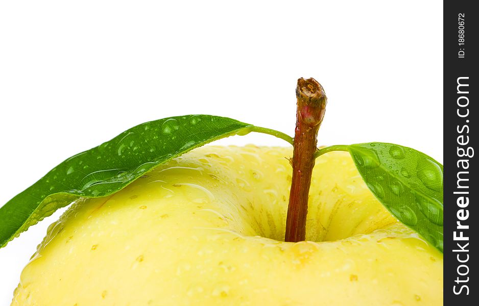 Fresh yellow apple with leaf. Isolated on white background.