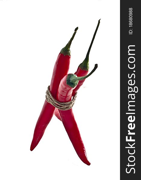 Bunch of red hot chilli pepper, tied by rope isolated on white background