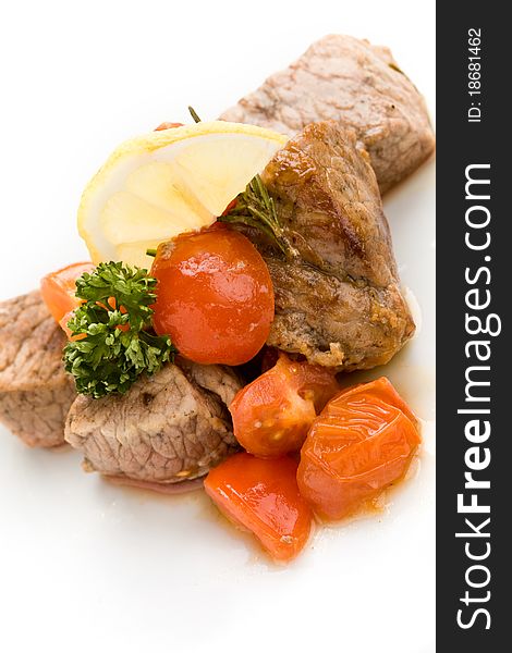 Photo of delicious meat with fresh tomatoes lemon and parsley