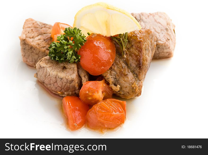 Photo of delicious meat with fresh tomatoes lemon and parsley