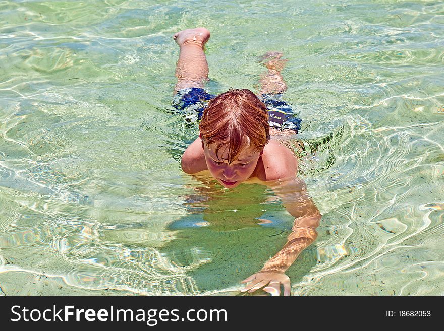 Boy Has Fun In The Clear  Ocean