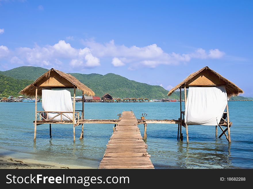 Wooden beach bungalows with pier over water. Wooden beach bungalows with pier over water