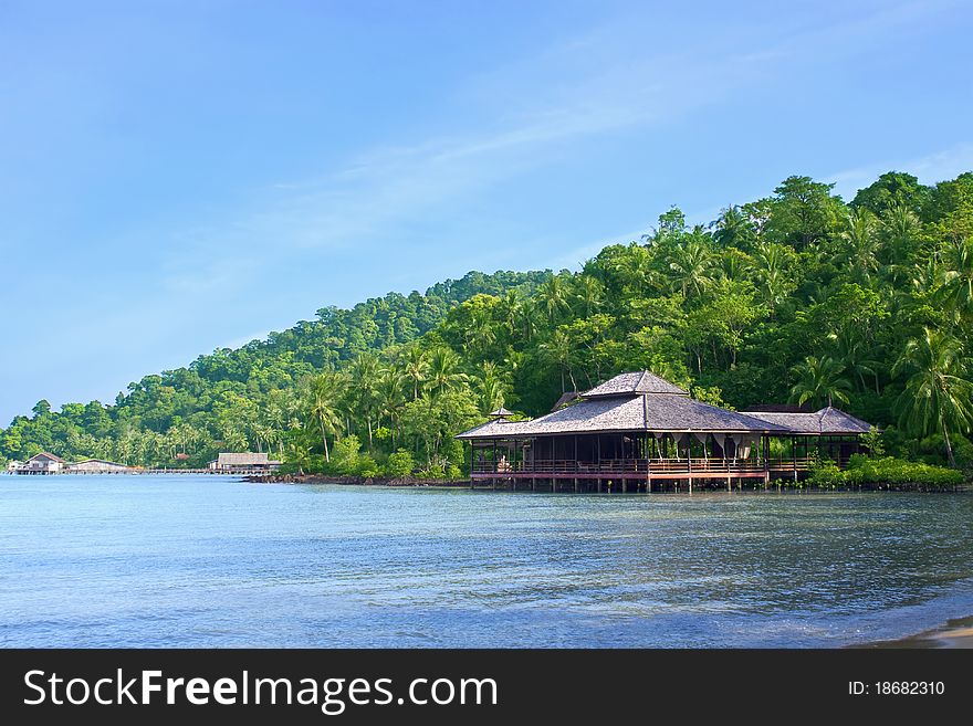 Wooden beach hotel on green paradise island