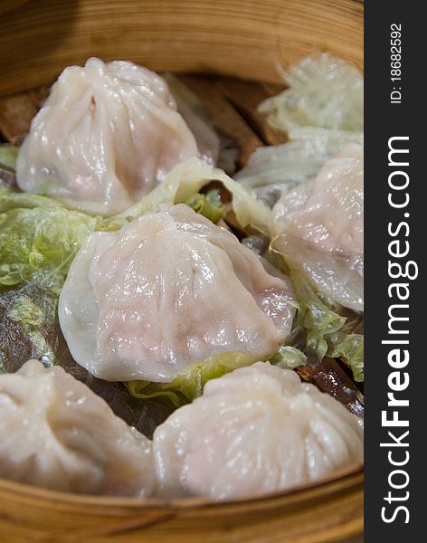 Steamed dumplings in traditional wooden steamer