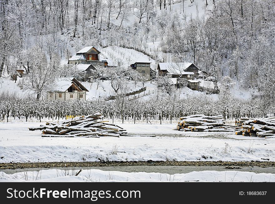 Forest snowy cottage near frost river. Forest snowy cottage near frost river