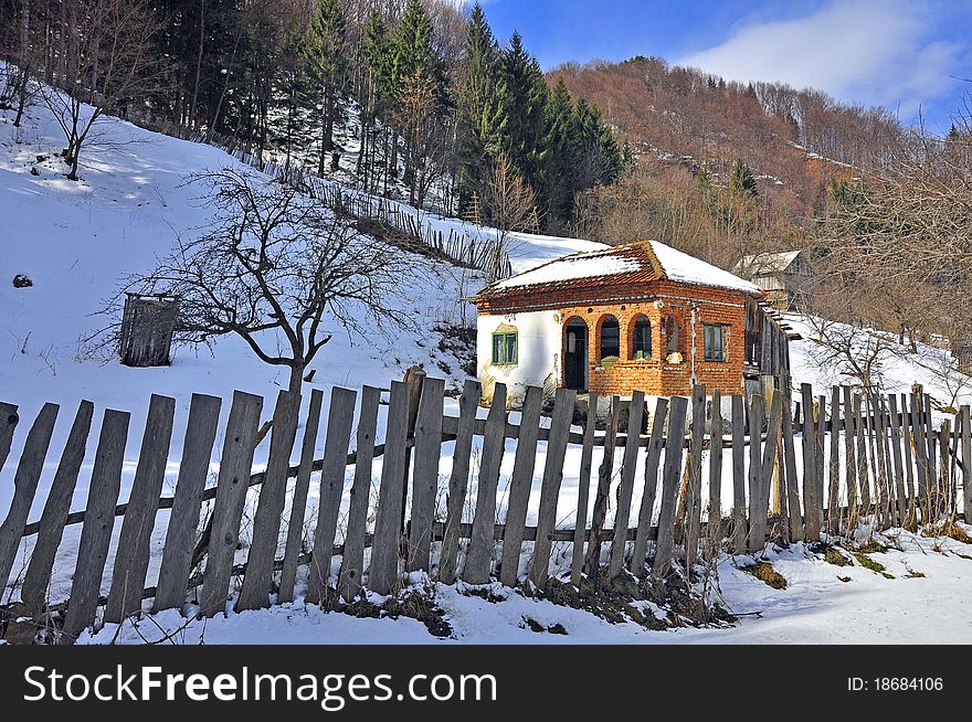 Wooden fence household in sunny winter time