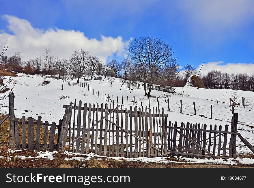 Wooden fence household in sunny winter time. Wooden fence household in sunny winter time