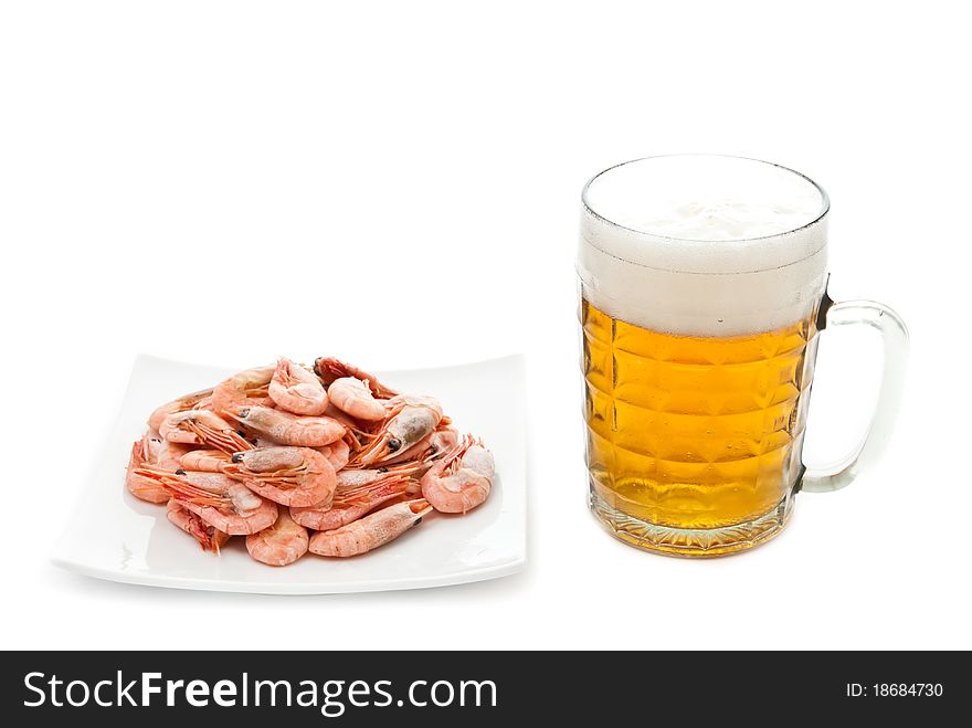 Fresh, cold beer in glass and fried prawns on plate. Isolated on white background. Fresh, cold beer in glass and fried prawns on plate. Isolated on white background