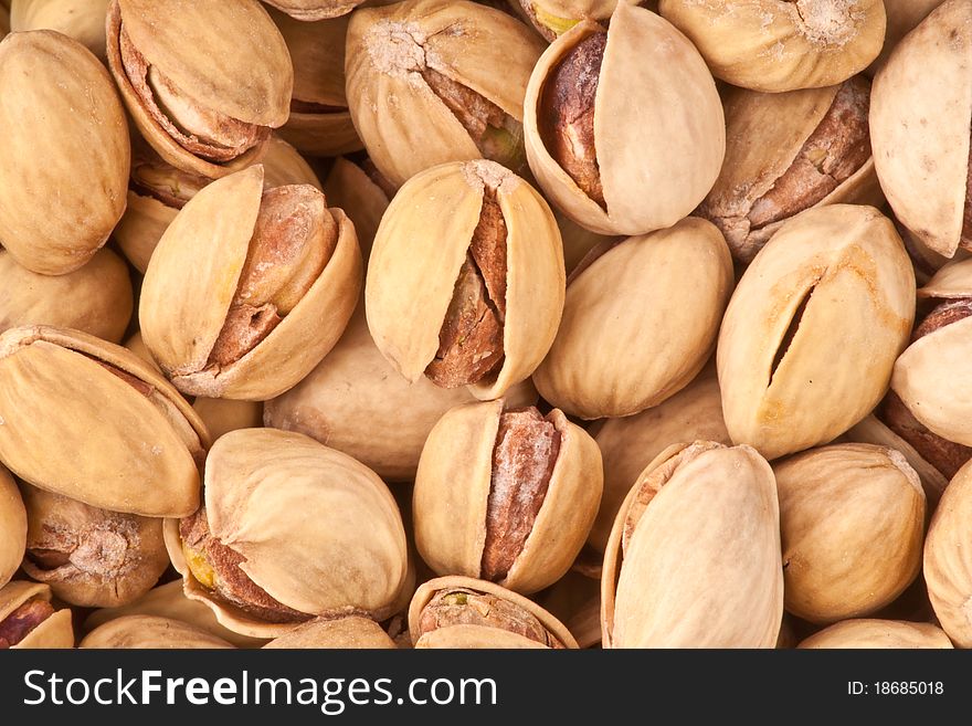 A close-up of a group of pistachios.