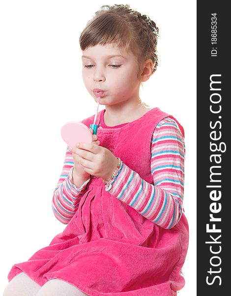 Young girl applies lipstick. Isolated on a white background. Young girl applies lipstick. Isolated on a white background.