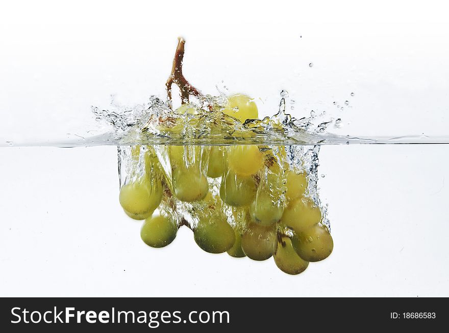 The grapes dropped into water. The grapes dropped into water