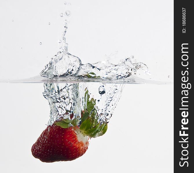 The strawberries dropped into water. The strawberries dropped into water