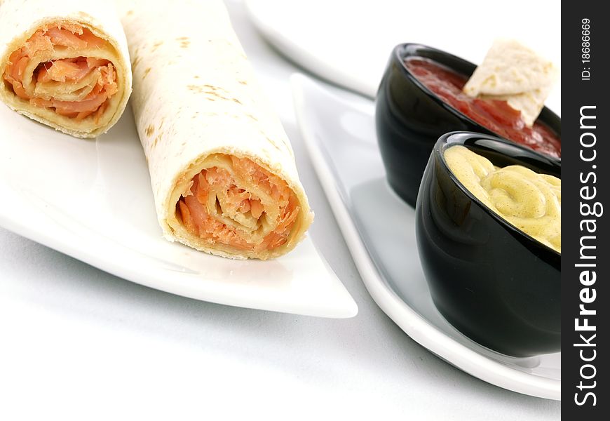 Tortilla wrap with salmon on a plate. Tortilla wrap with salmon on a plate