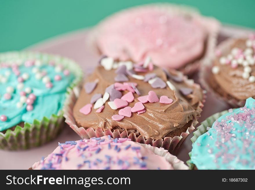 Homemade cupcakes with frosting on a pastell table