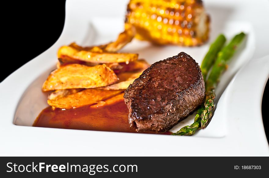 Some beef with potatoes sauce and corn