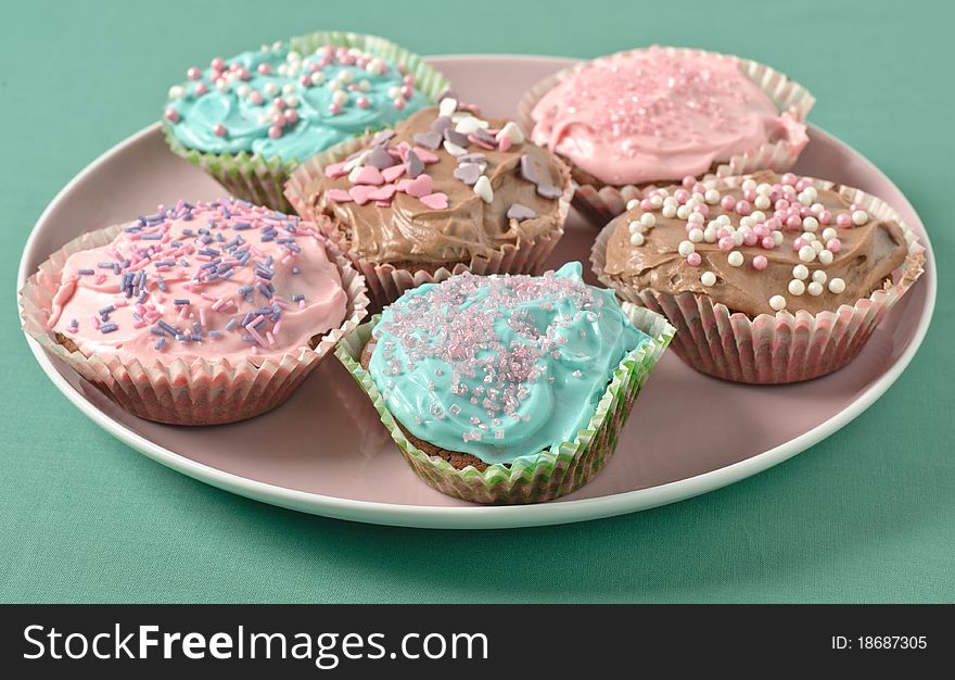 Homemade cupcakes with frosting on a pastell table