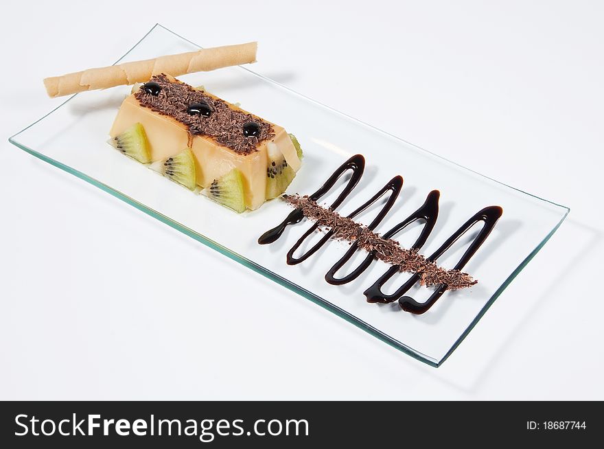 Custard with kiwi pieces, rolled wafer and chocolate. Custard with kiwi pieces, rolled wafer and chocolate