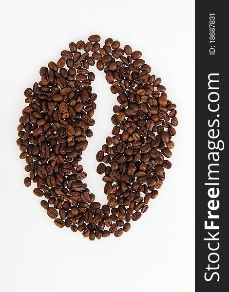 Roasted beans gathered in a shape of coffee on the white background