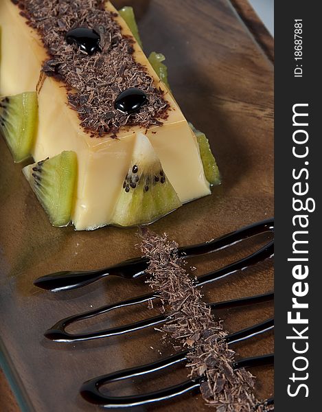 Custard with kiwi pieces, rolled wafer and chocolate. Custard with kiwi pieces, rolled wafer and chocolate