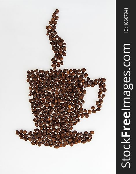 Roasted beans gathered in a shape of coffee cup on the white background