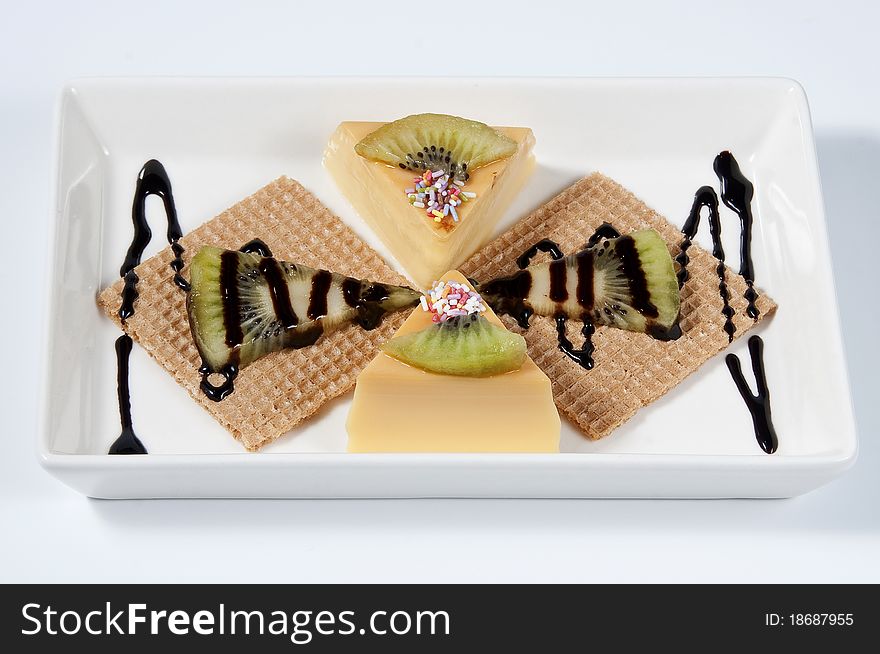 Custard with kiwi pieces, rolled wafer and chocolate. Custard with kiwi pieces, rolled wafer and chocolate