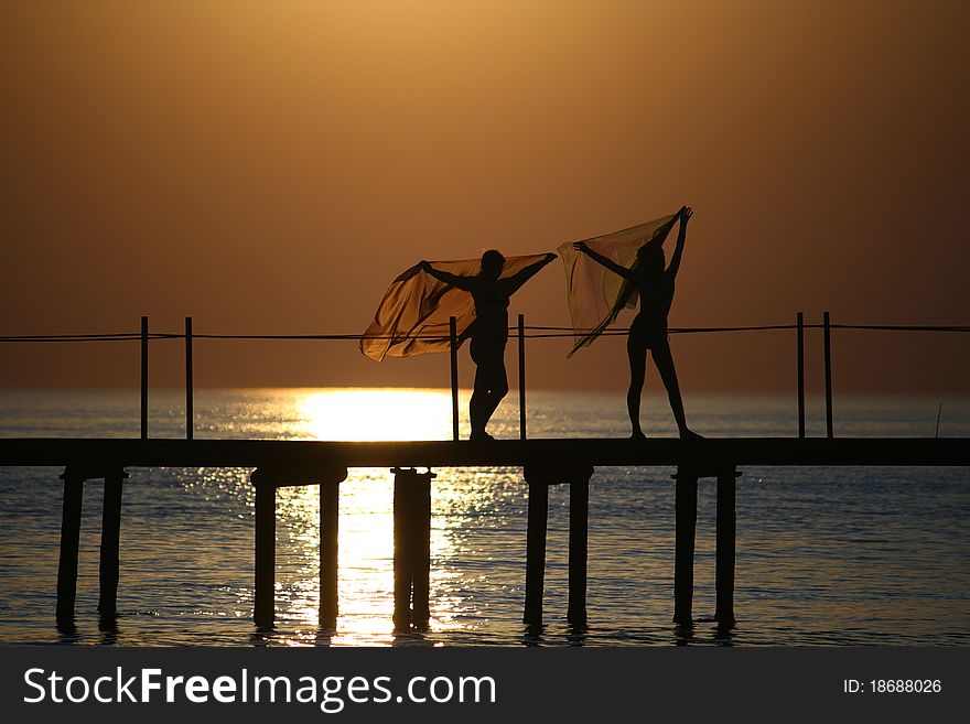 Girls On A Bridge At Sunset.