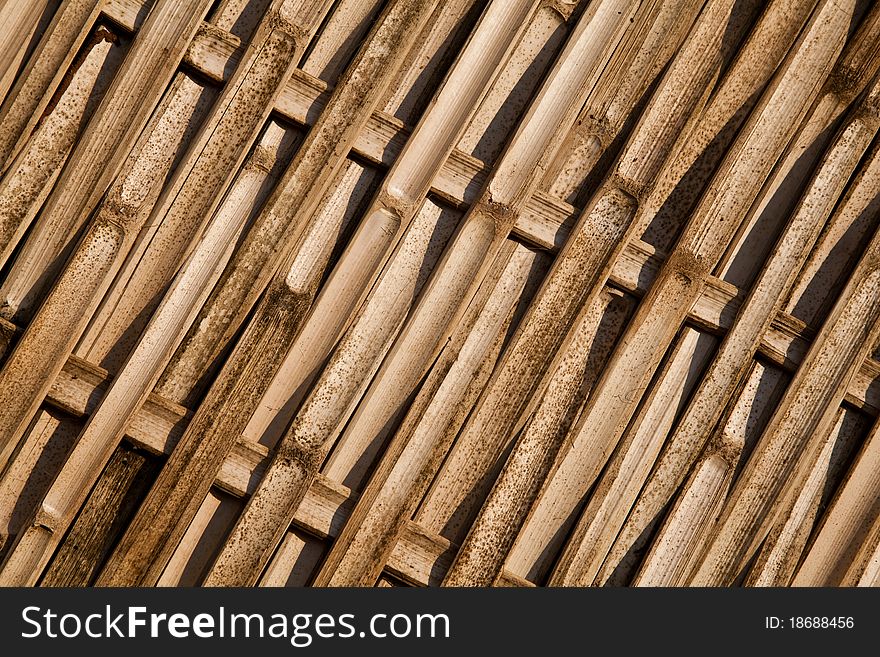 The bamboo panel made from pieces of bamboo wood and arranged in asian traditional pattern.