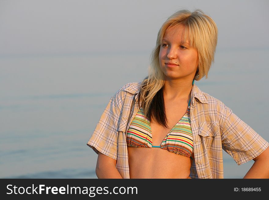 Girl posing. Water on background