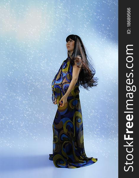 Asian pregnant woman in transparent dress on blue background with radiance. Asian pregnant woman in transparent dress on blue background with radiance